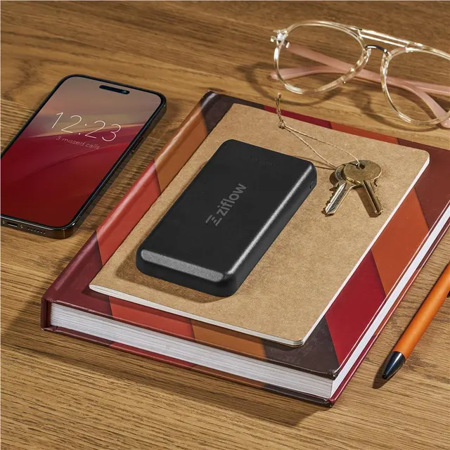 Branded power bank on a desk with a notebook